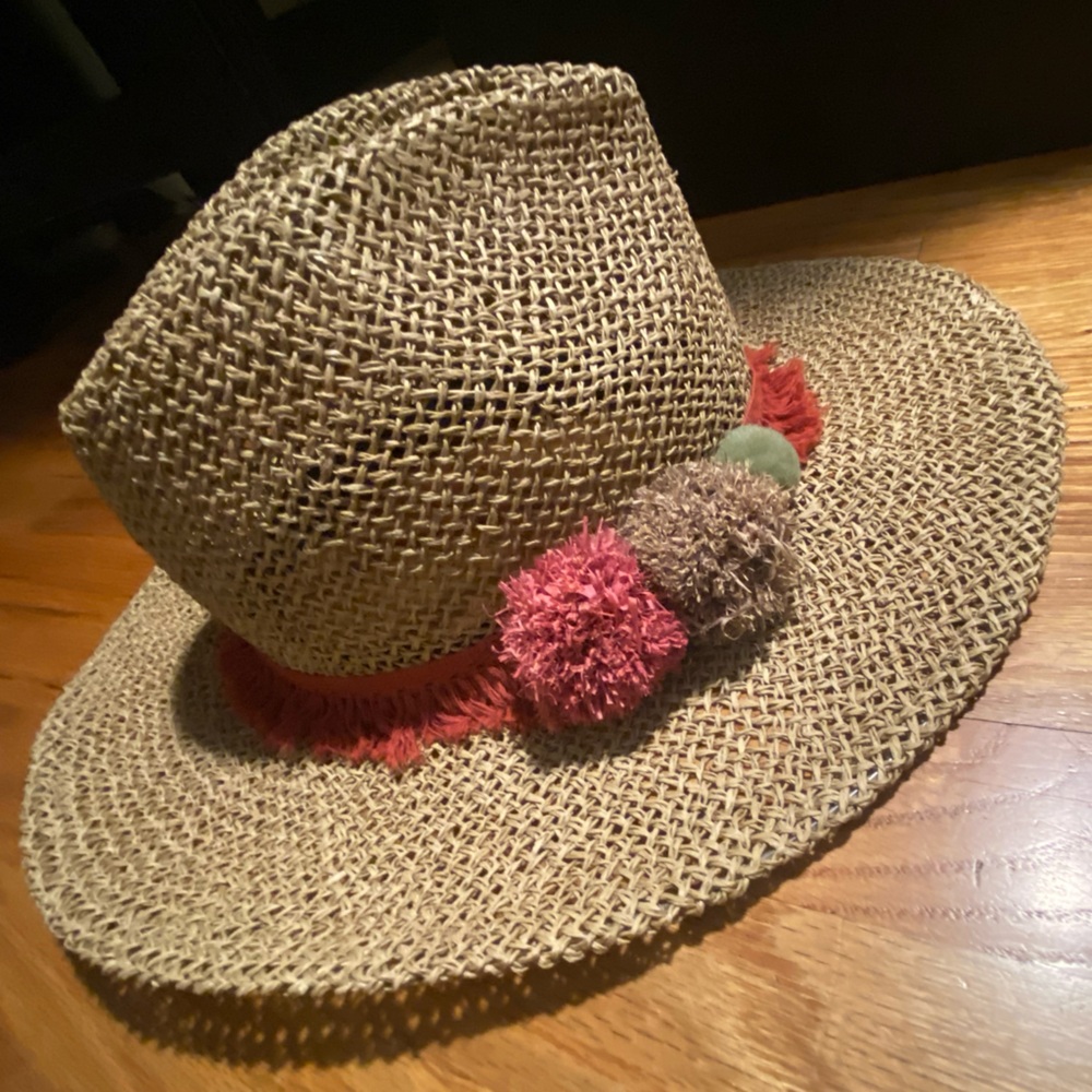 Zara woven hat with burnt orange and lavender pom poms and fringe hat band.